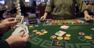 The picture shows Pai Gow Poker table and someone playing 